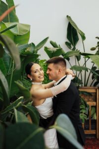 romantic wedding couple embracing in lush greenery