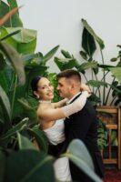 romantic wedding couple embracing in lush greenery