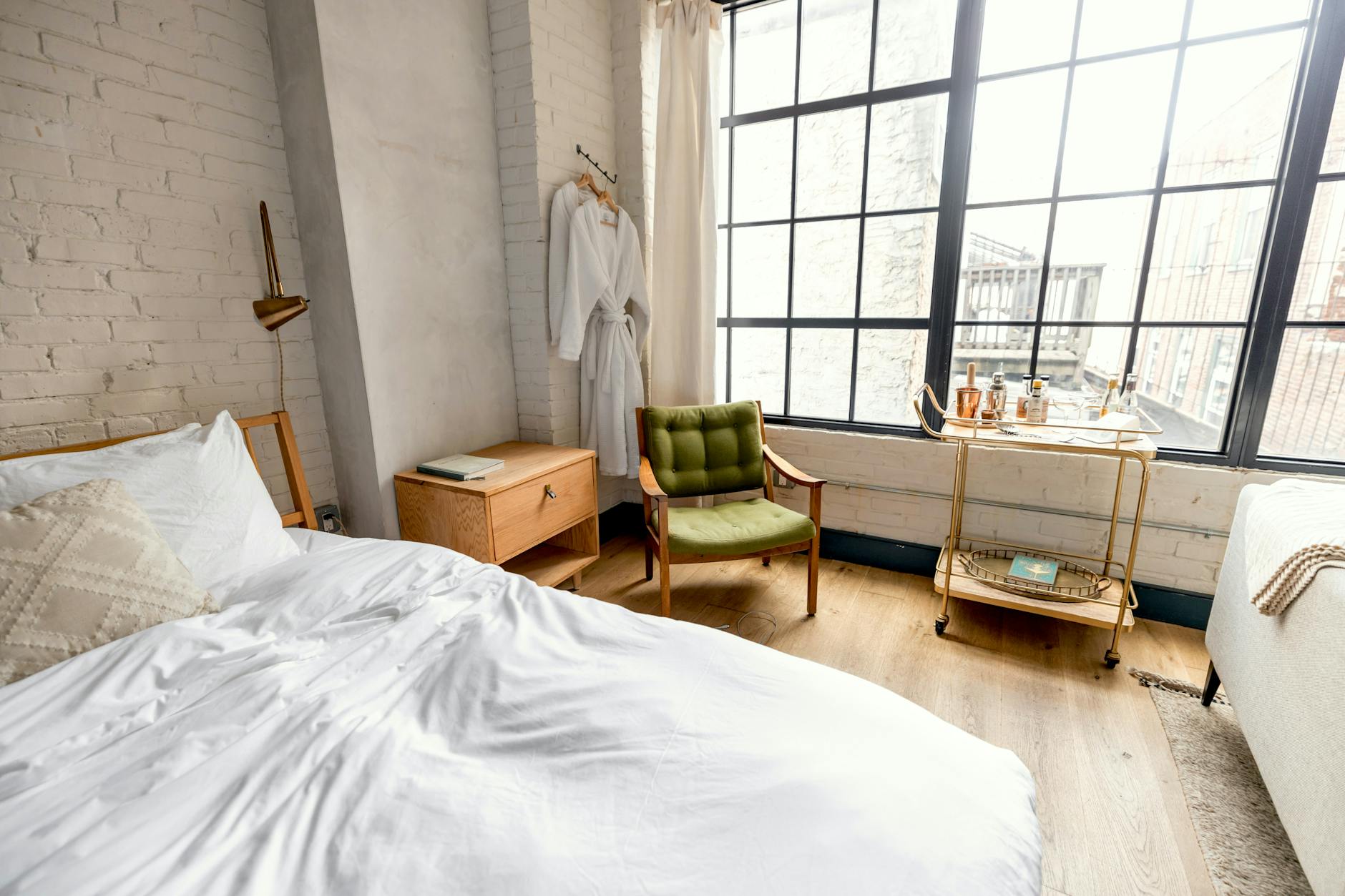 white bed linen near brown wooden chair