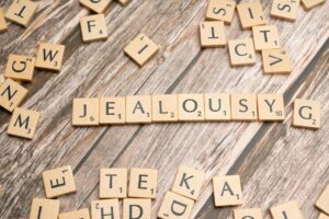 scrabble blocks forming jealousy word