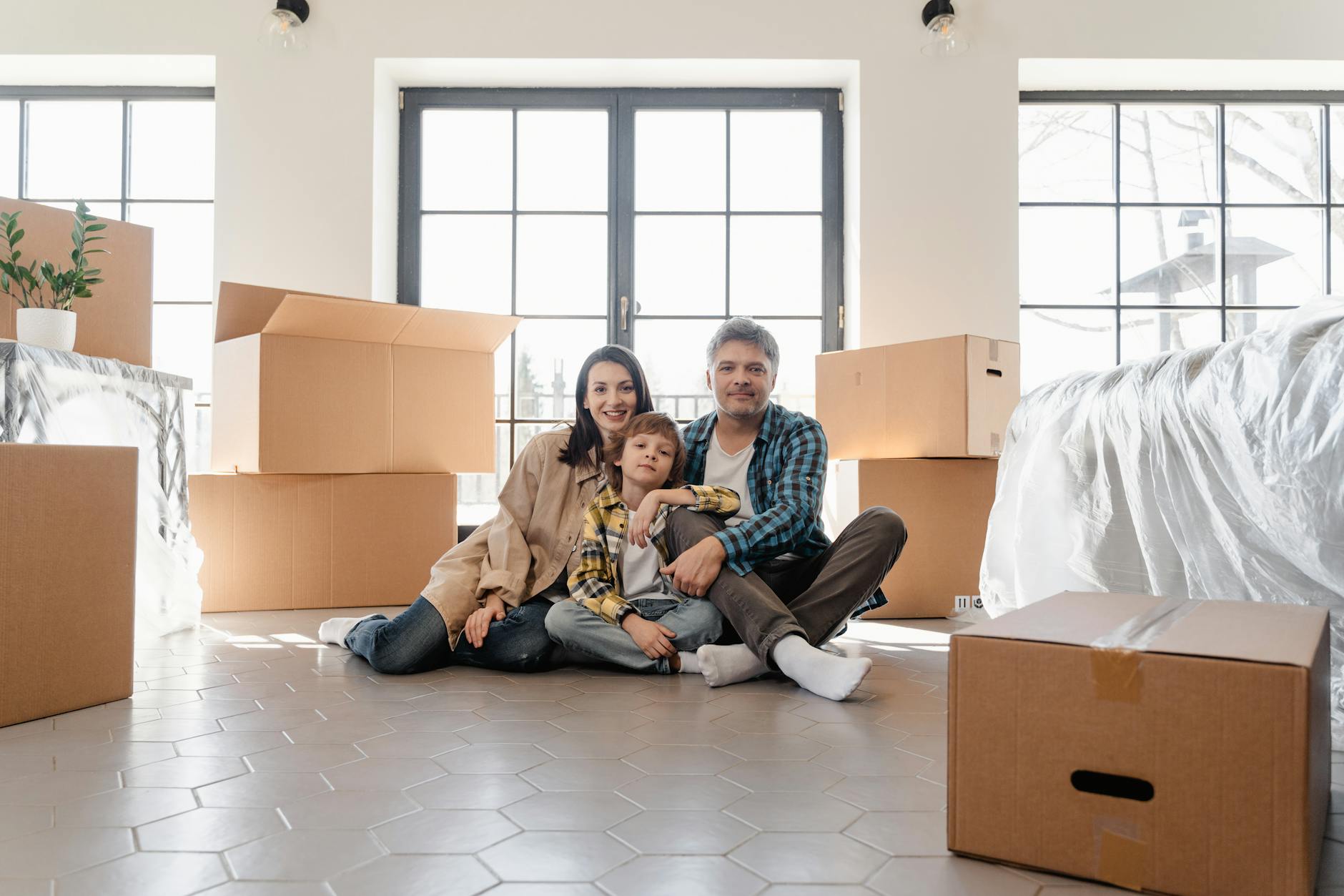 a newly moved family sitting on the floor