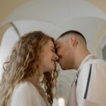 a couple smiling leaning their faces close to one another