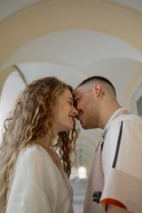 a couple smiling leaning their faces close to one another