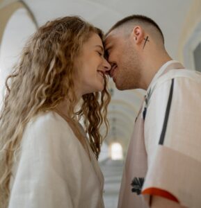 a couple smiling leaning their faces close to one another