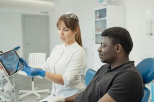 a dentist showing a patient a dental x ray result